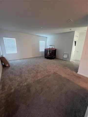 a view of a room with furniture and a window