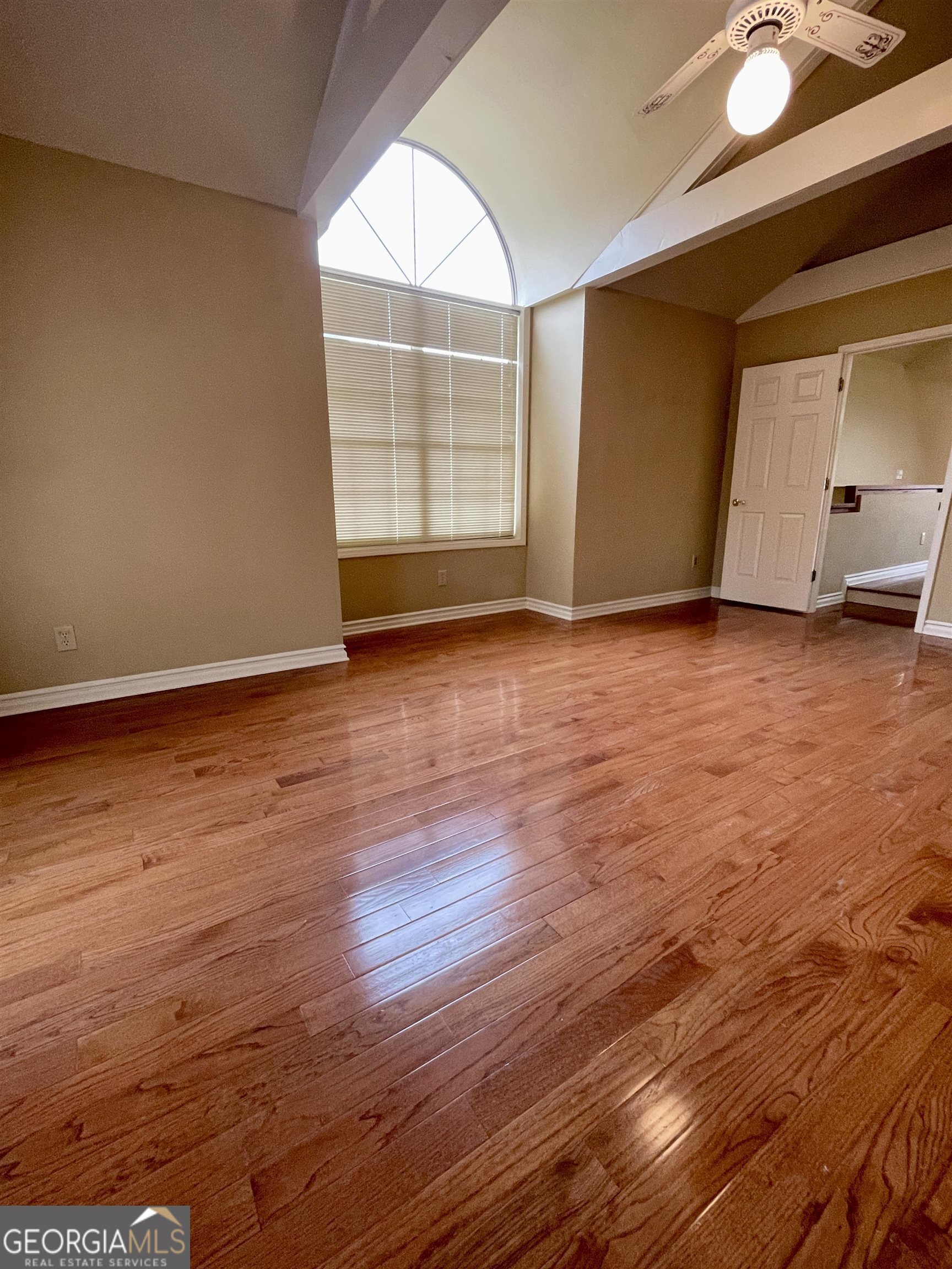 242 Ebenezer Church Road Fayetteville, GA 30215 - Photo 11 of 43 an empty room with wooden floor and windows