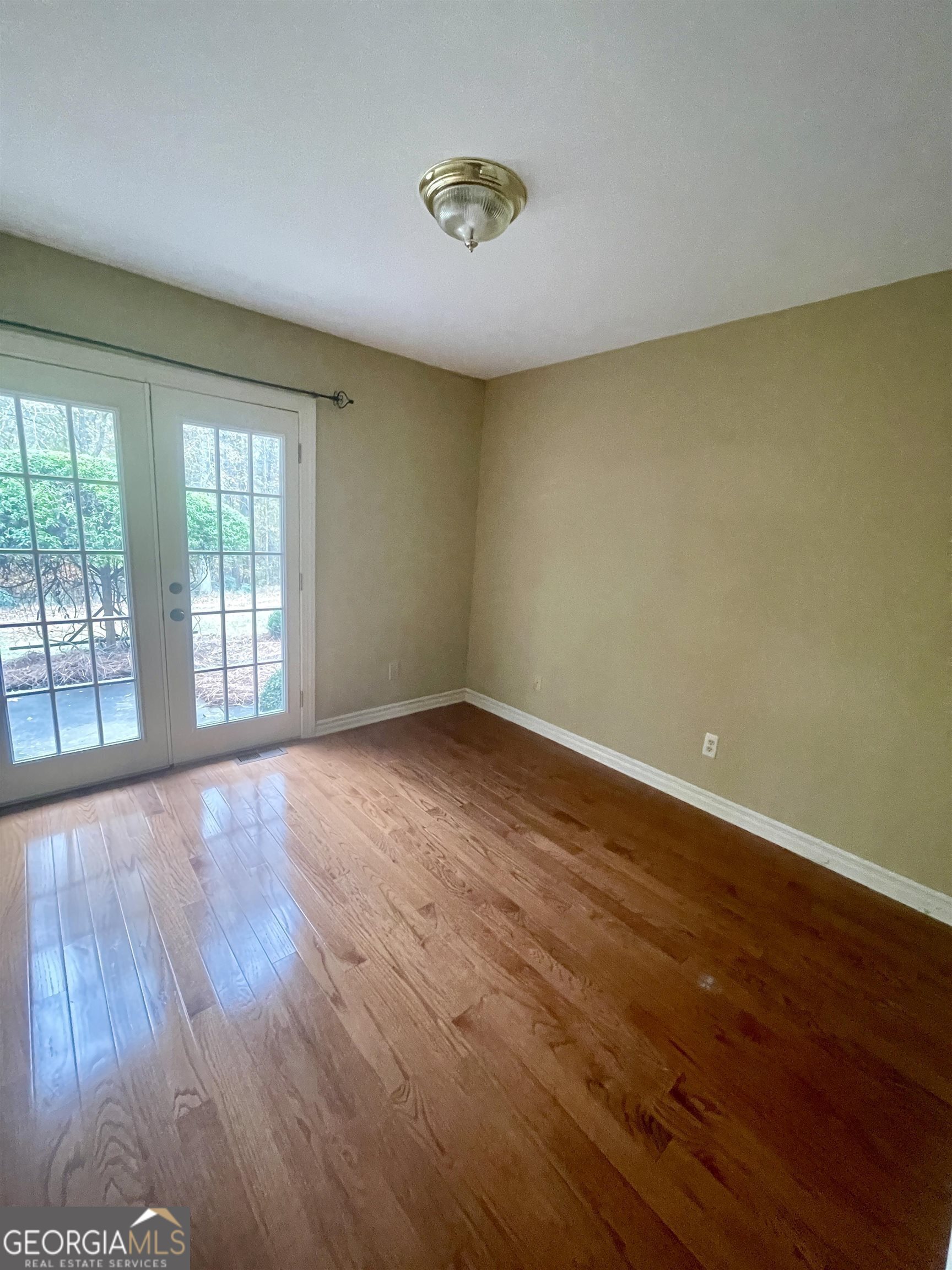 242 Ebenezer Church Road Fayetteville, GA 30215 - Photo 23 of 43 a view of an empty room with wooden floor and a window