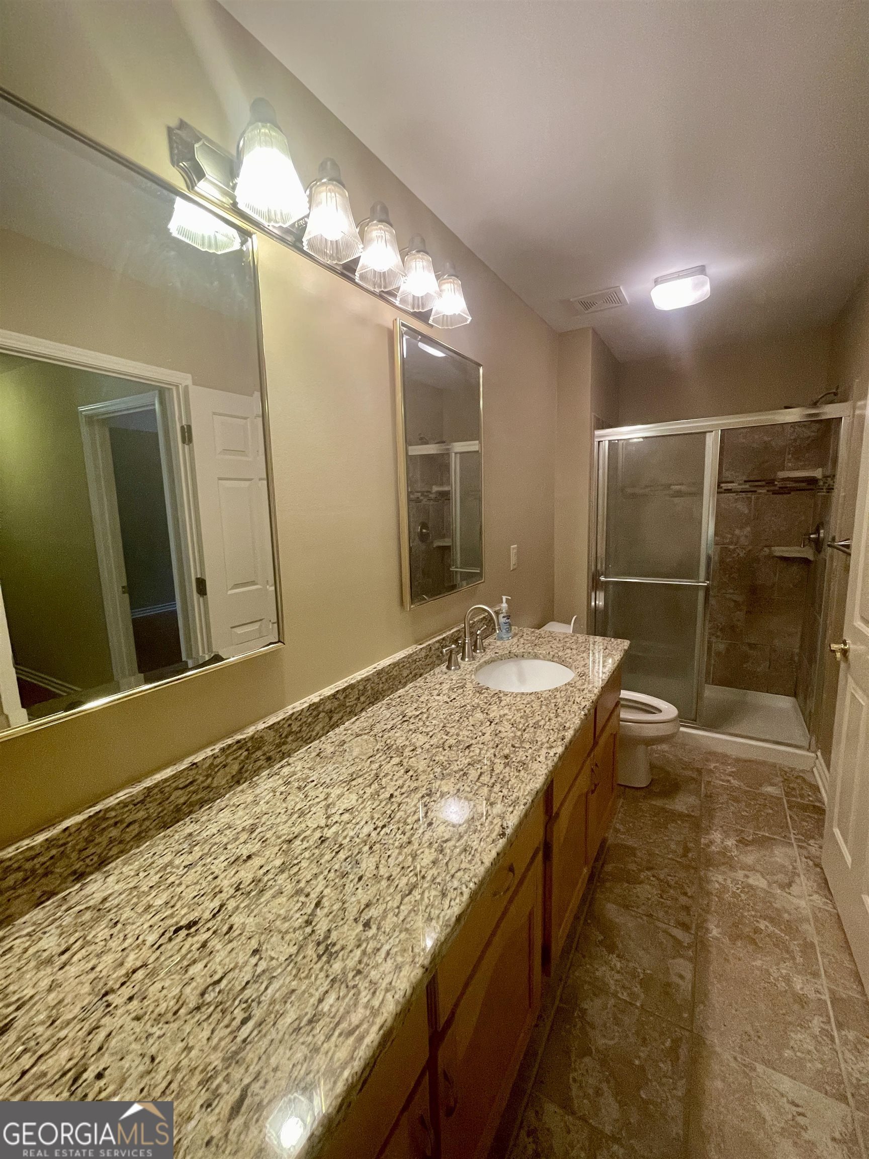 242 Ebenezer Church Road Fayetteville, GA 30215 - Photo 24 of 43 a bathroom with a granite countertop sink and a large mirror
