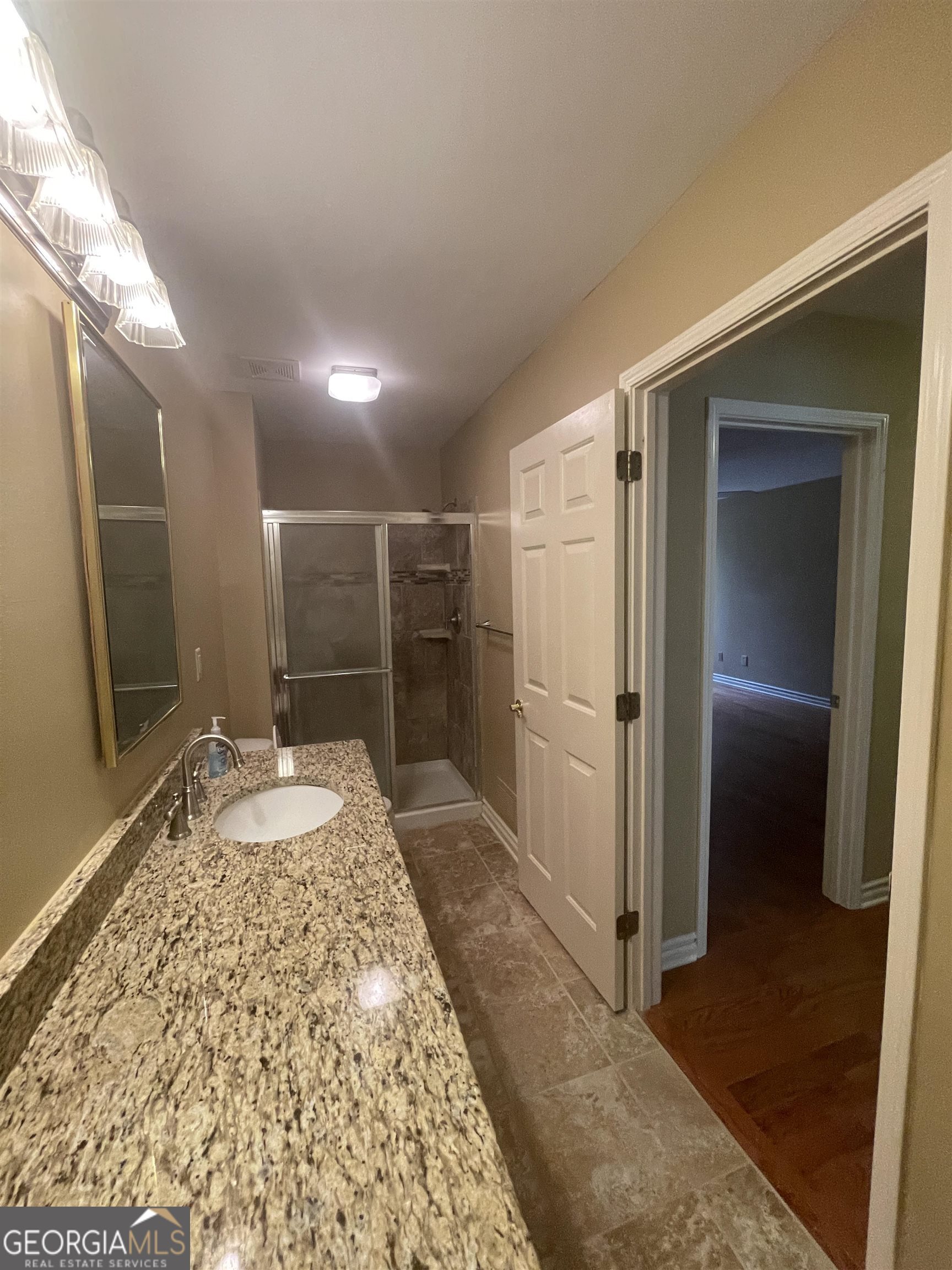 242 Ebenezer Church Road Fayetteville, GA 30215 - Photo 25 of 43 a bathroom with a granite countertop sink and a mirror
