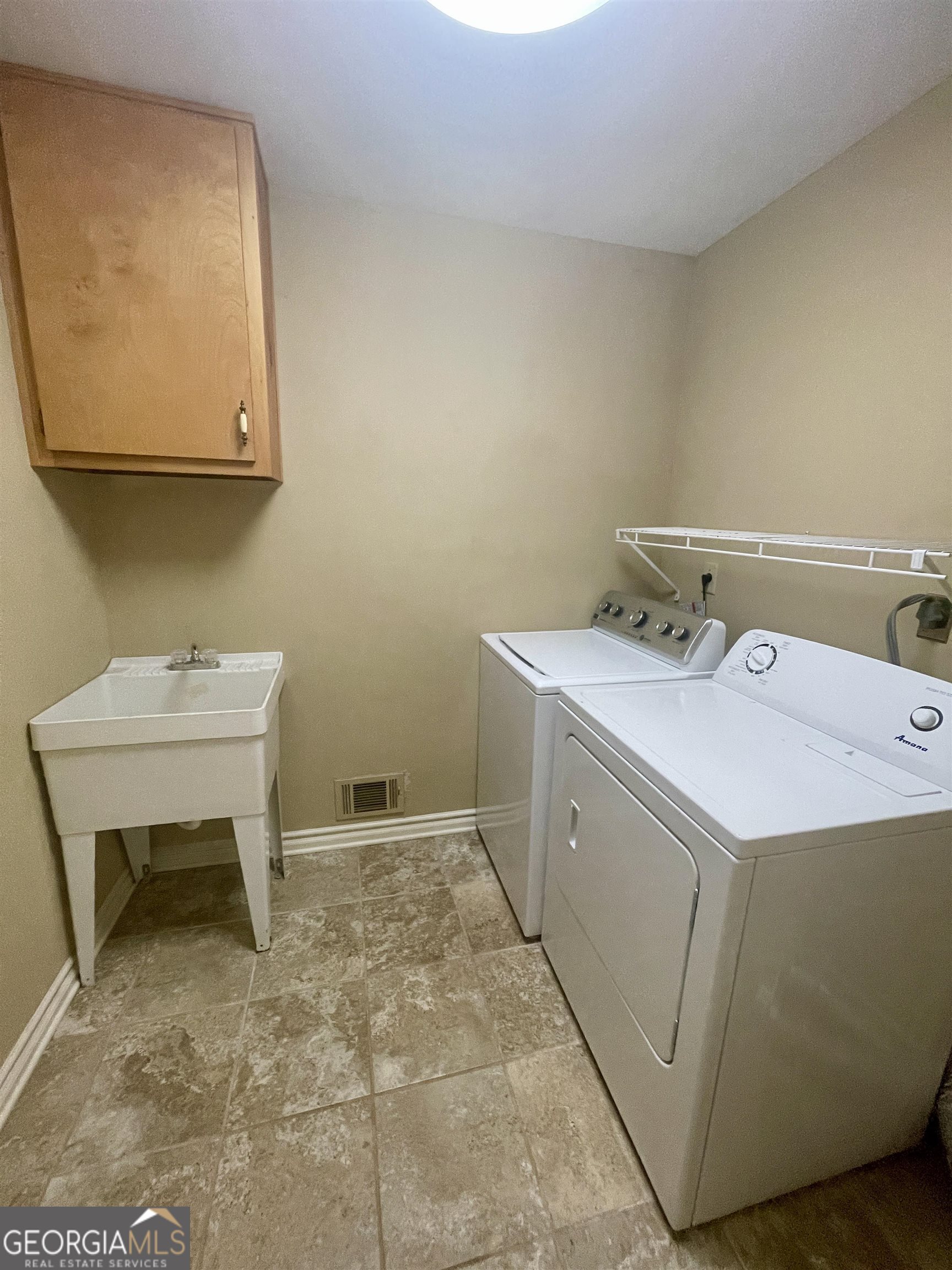 242 Ebenezer Church Road Fayetteville, GA 30215 - Photo 30 of 43 a utility room with a sink dryer and washer