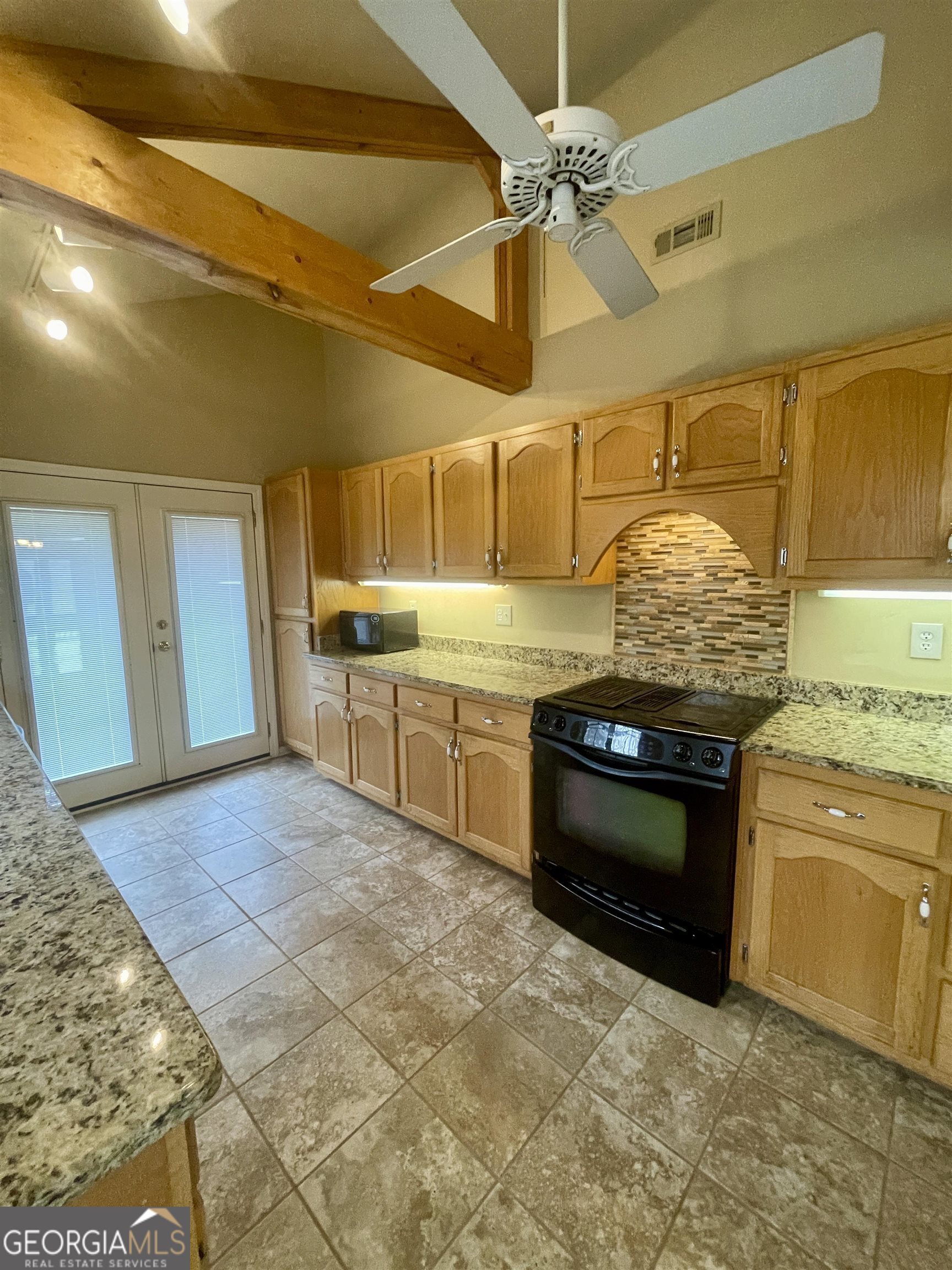 242 Ebenezer Church Road Fayetteville, GA 30215 - Photo 8 of 43 a kitchen with stainless steel appliances granite countertop a stove a sink and a refrigerator