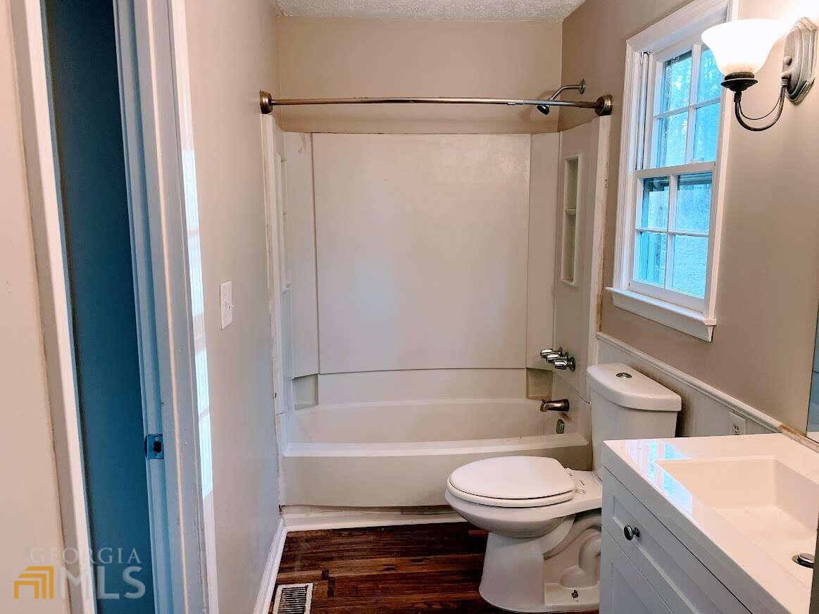 1939 Bonnie Ridge Drive Griffin, GA 30223 - Photo 11 of 23 a bathroom with a sink a toilet and shower