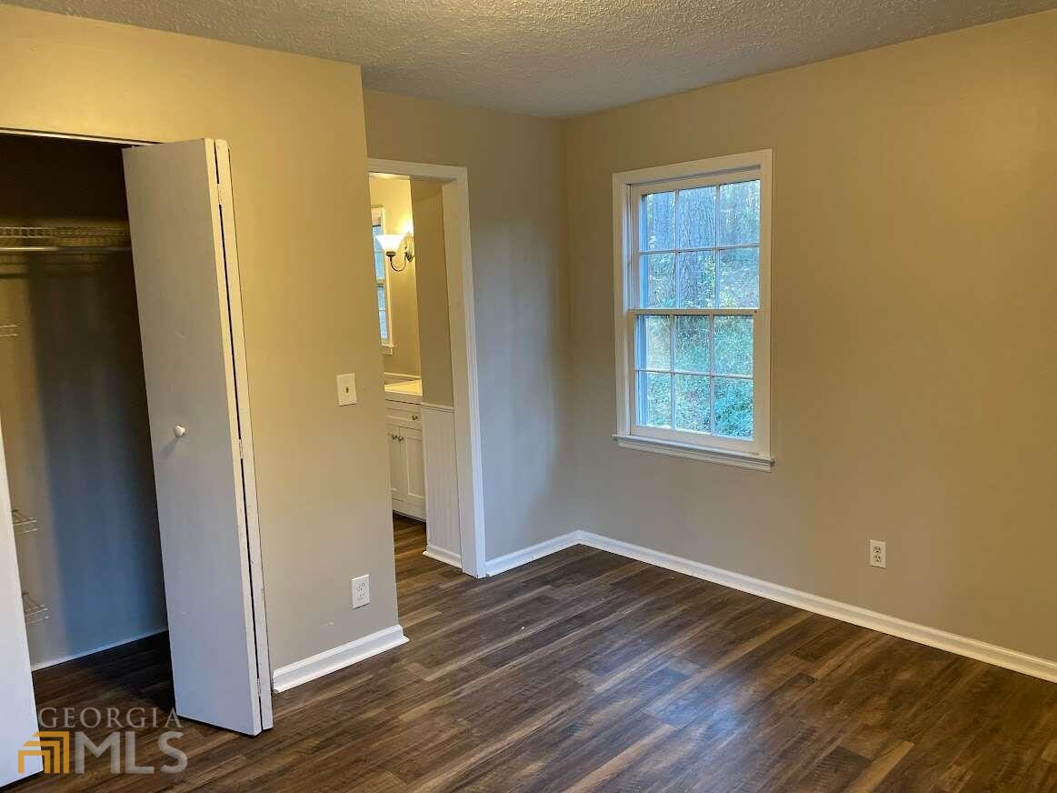 1939 Bonnie Ridge Drive Griffin, GA 30223 - Photo 12 of 23 a view of an empty room with wooden floor and a window