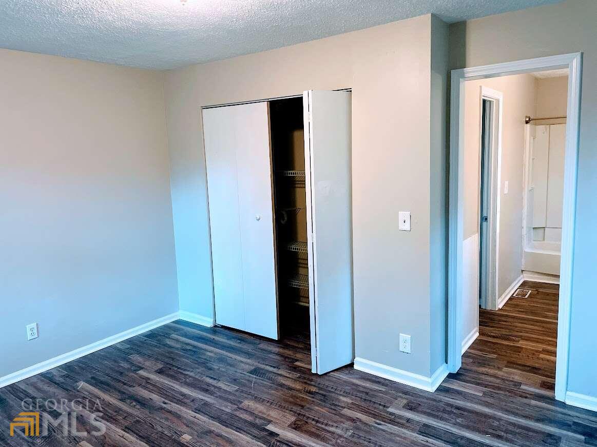 1939 Bonnie Ridge Drive Griffin, GA 30223 - Photo 13 of 23 a view of a hallway with wooden floor and staircase