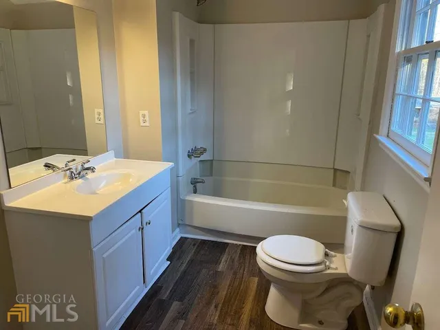 a bathroom with a sink a toilet and bathtub