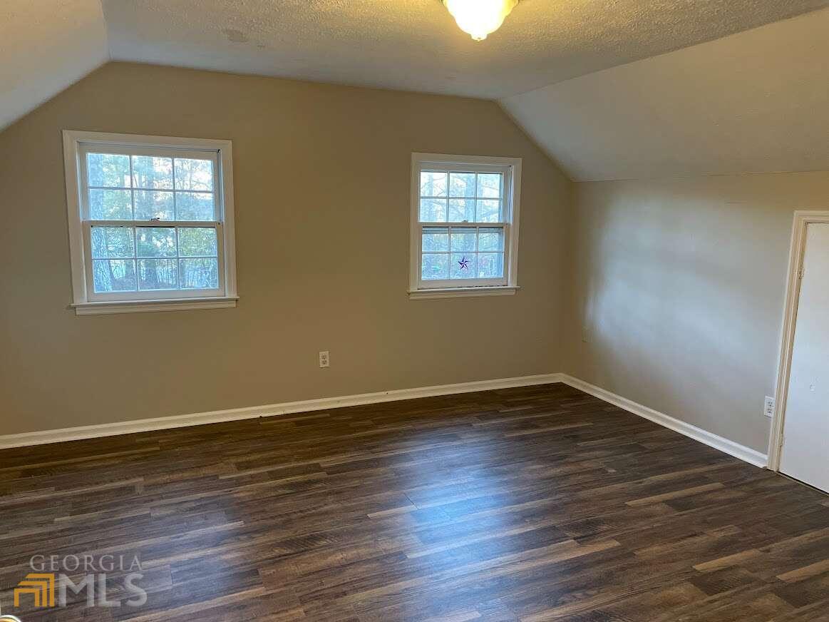 1939 Bonnie Ridge Drive Griffin, GA 30223 - Photo 19 of 23 a view of an empty room with wooden floor and a window