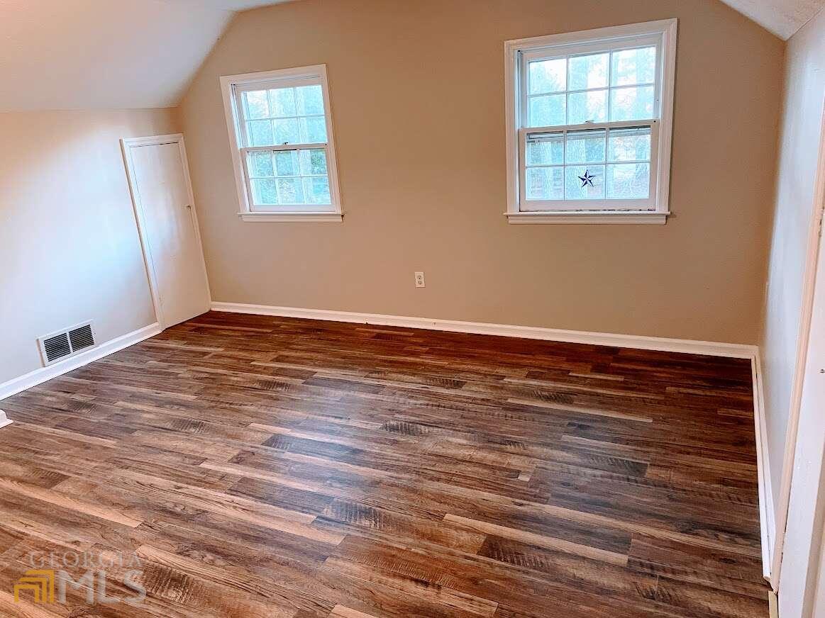 1939 Bonnie Ridge Drive Griffin, GA 30223 - Photo 21 of 23 an empty room with wooden floor and windows