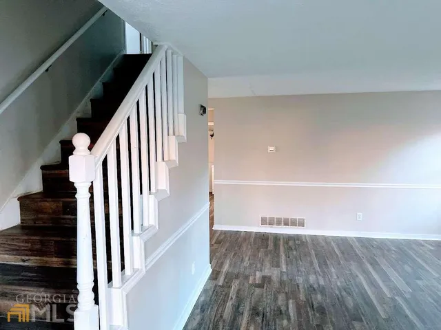 a view of entryway and hall with wooden floor