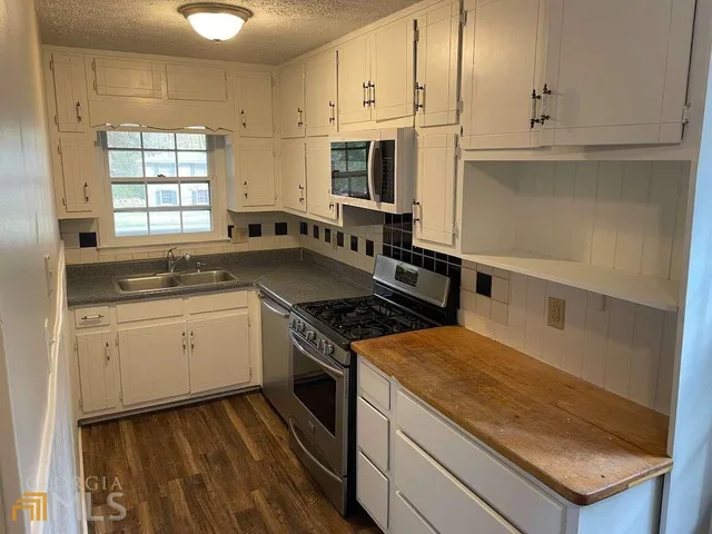 a kitchen with a stove oven and sink