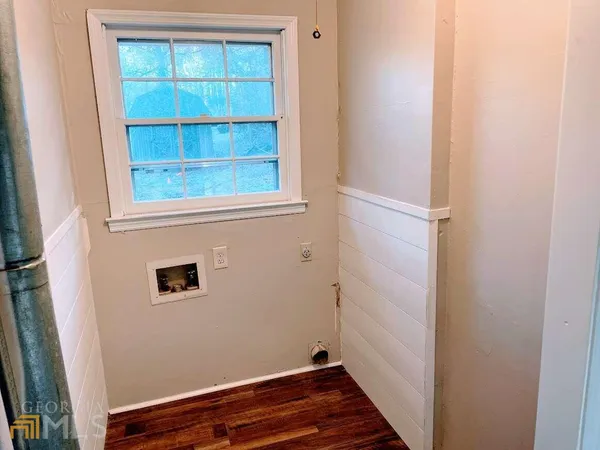 a view of a room with rack on the wall and a window