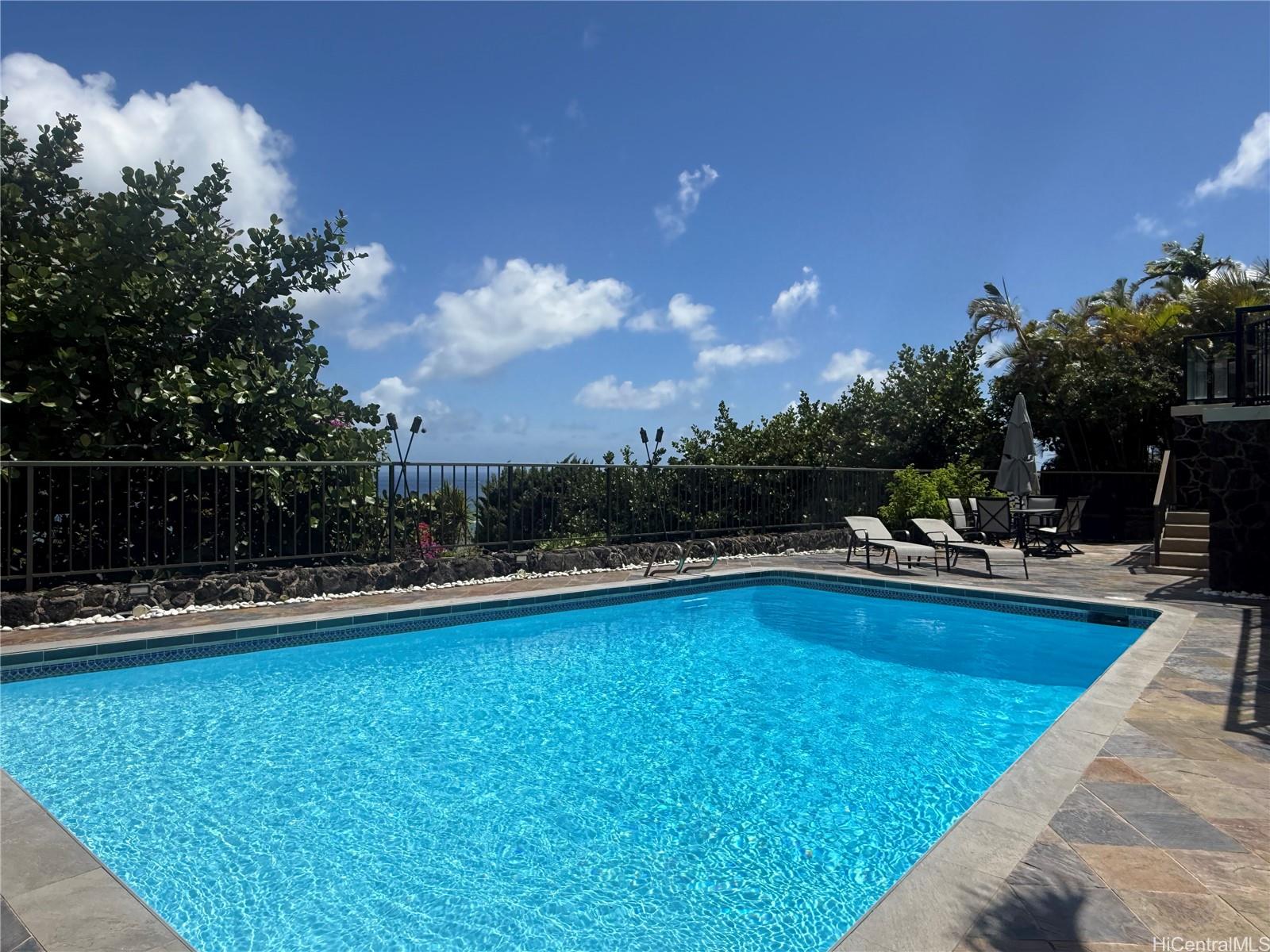 1632 Ihiloa Loop Honolulu, HI 96821 - Photo 13 of 24 a view of a swimming pool and lounge chairs