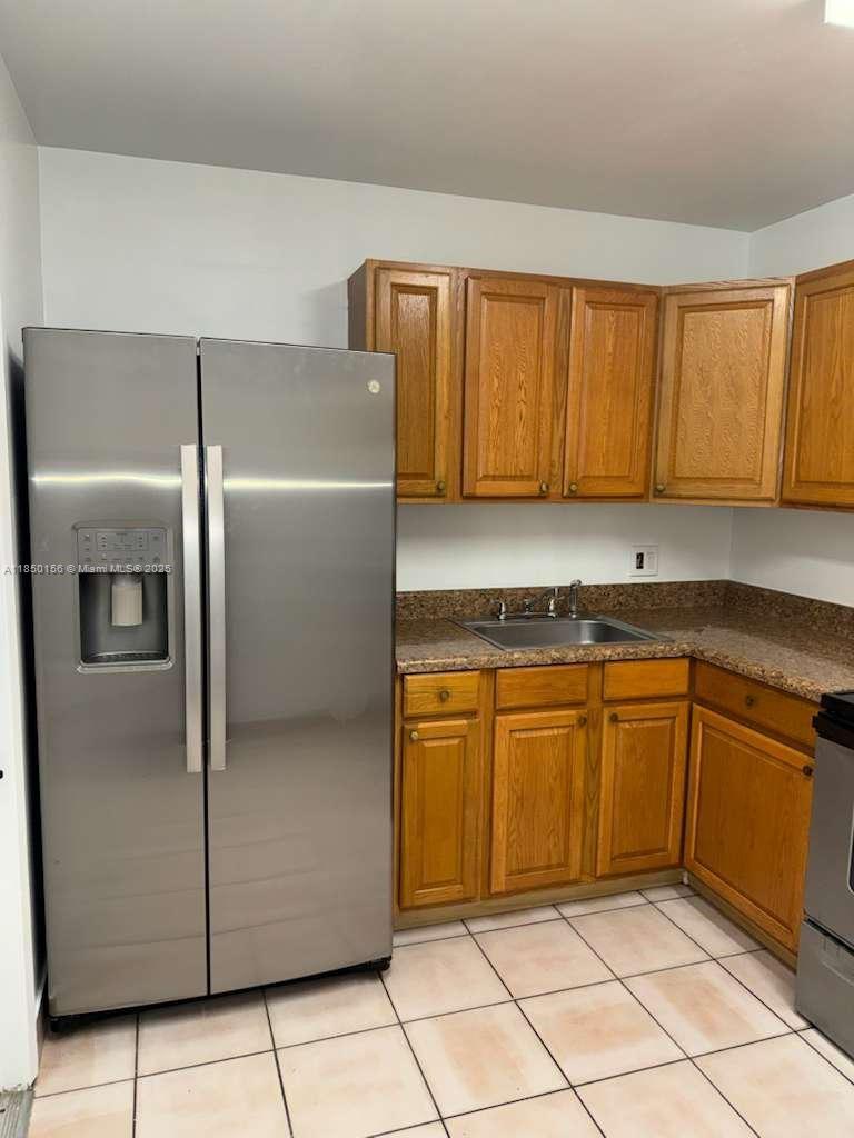 9203 Northwest 38th Drive, Unit 12 Coral Springs, FL 33065 - Photo 4 of 19 a kitchen with stainless steel appliances granite countertop a refrigerator and a sink