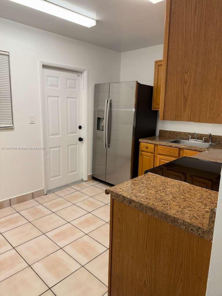 9203 Northwest 38th Drive, Unit 12 Coral Springs, FL 33065 - Photo 6 of 19 a kitchen with a refrigerator and a sink