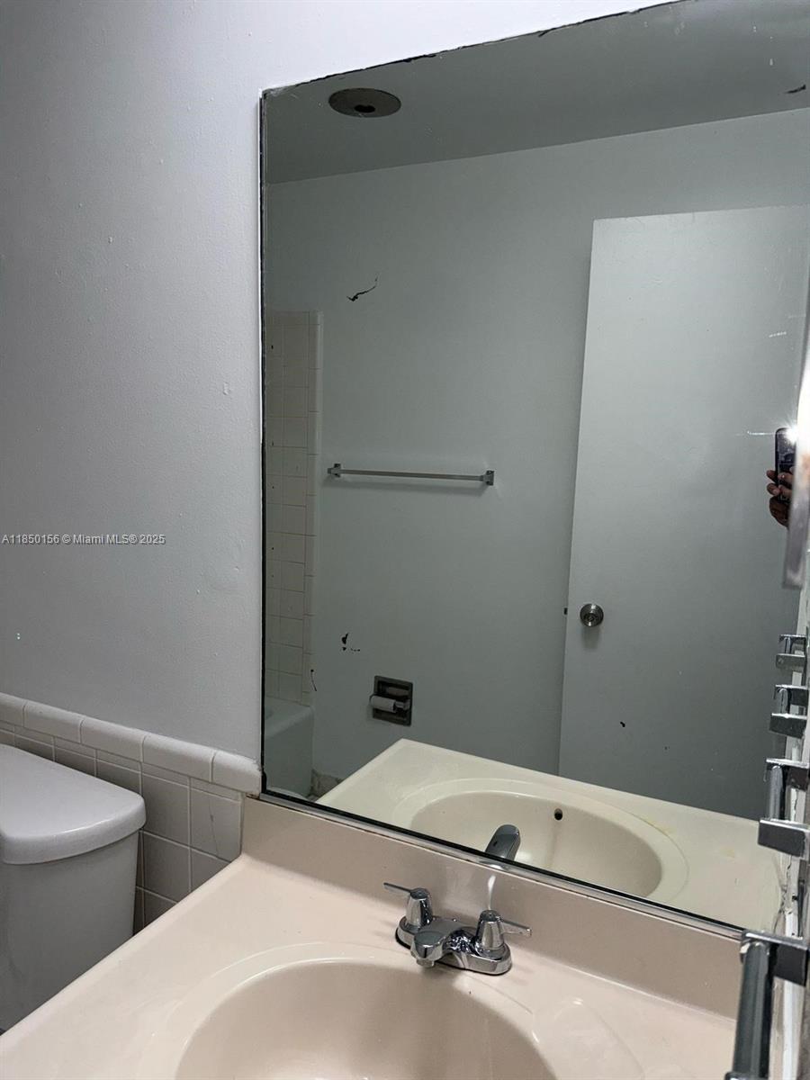 9203 Northwest 38th Drive, Unit 12 Coral Springs, FL 33065 - Photo 8 of 19 a bathroom with a sink and a toilet