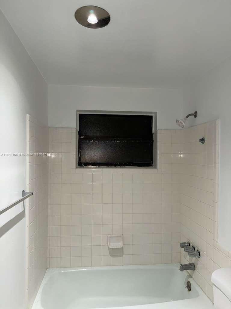 9203 Northwest 38th Drive, Unit 12 Coral Springs, FL 33065 - Photo 10 of 19 a bathroom with a shower