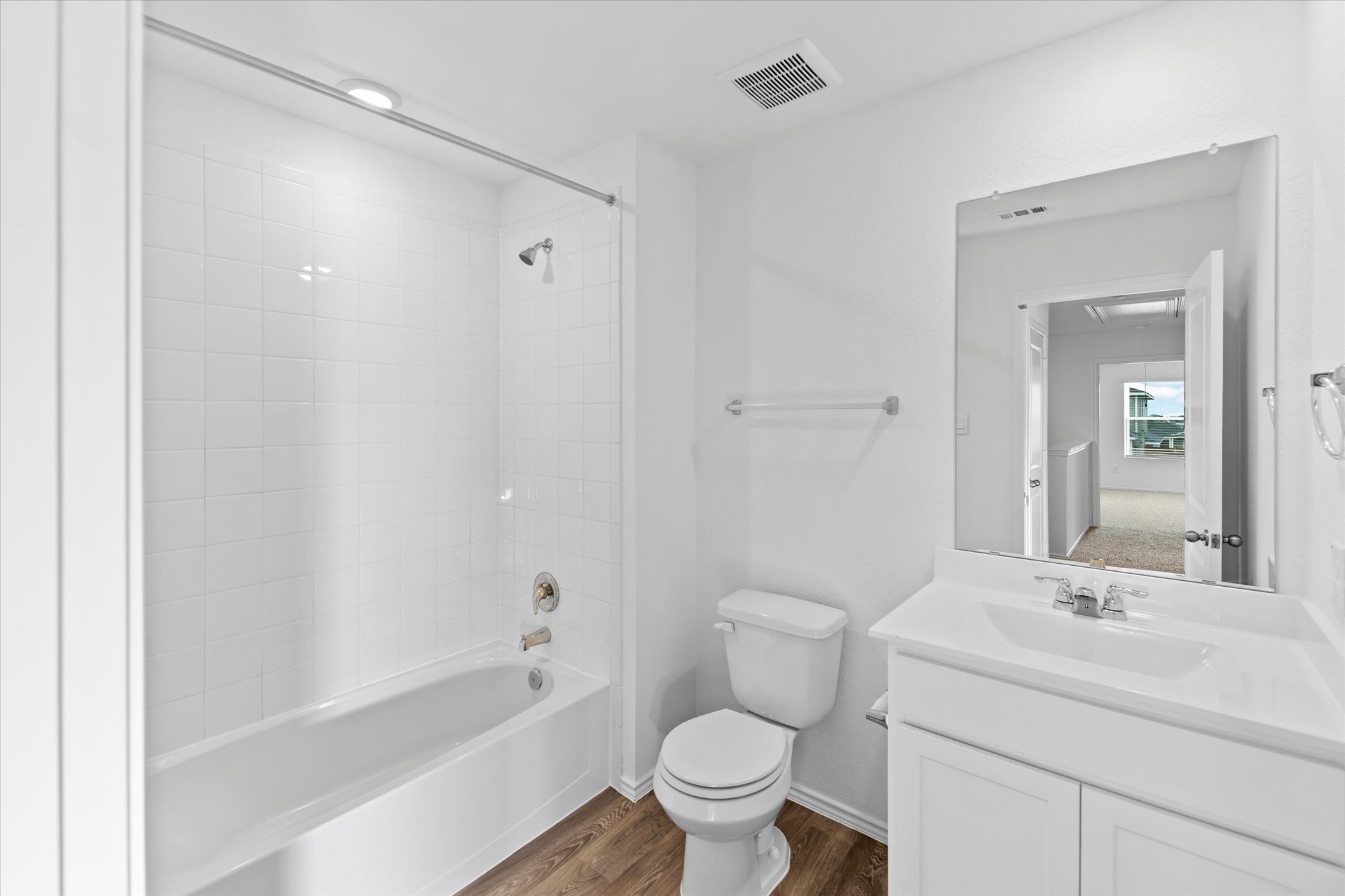 456 Sandringham Loop Kyle, TX 78640 - Photo 15 of 40 A well-appointed bathroom with durable wood-look flooring and clean, tiled shower walls.