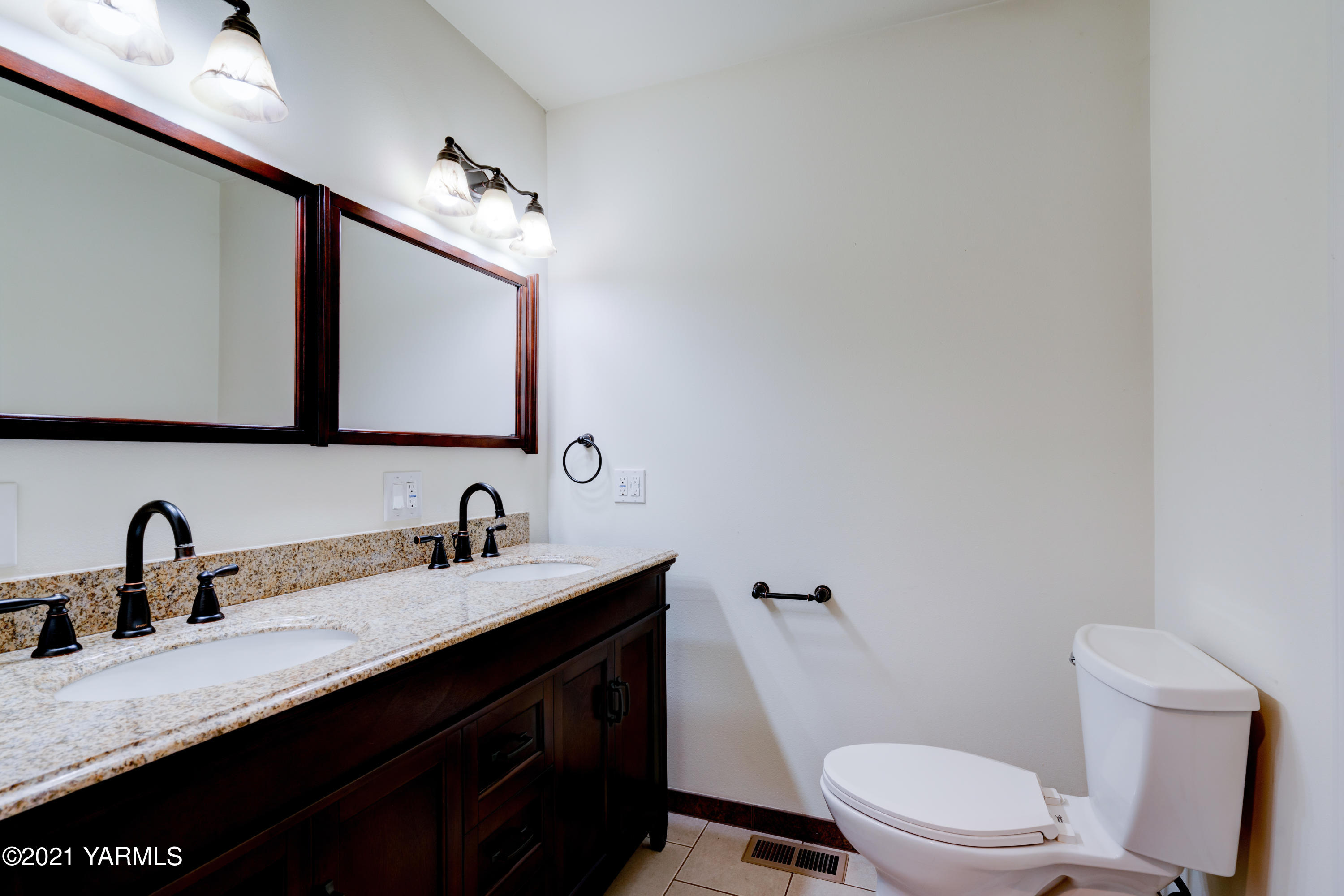 10805 Summitview Ext Road Yakima, WA 98908 - Photo 14 of 27 a bathroom with a double vanity sink toilet and mirror
