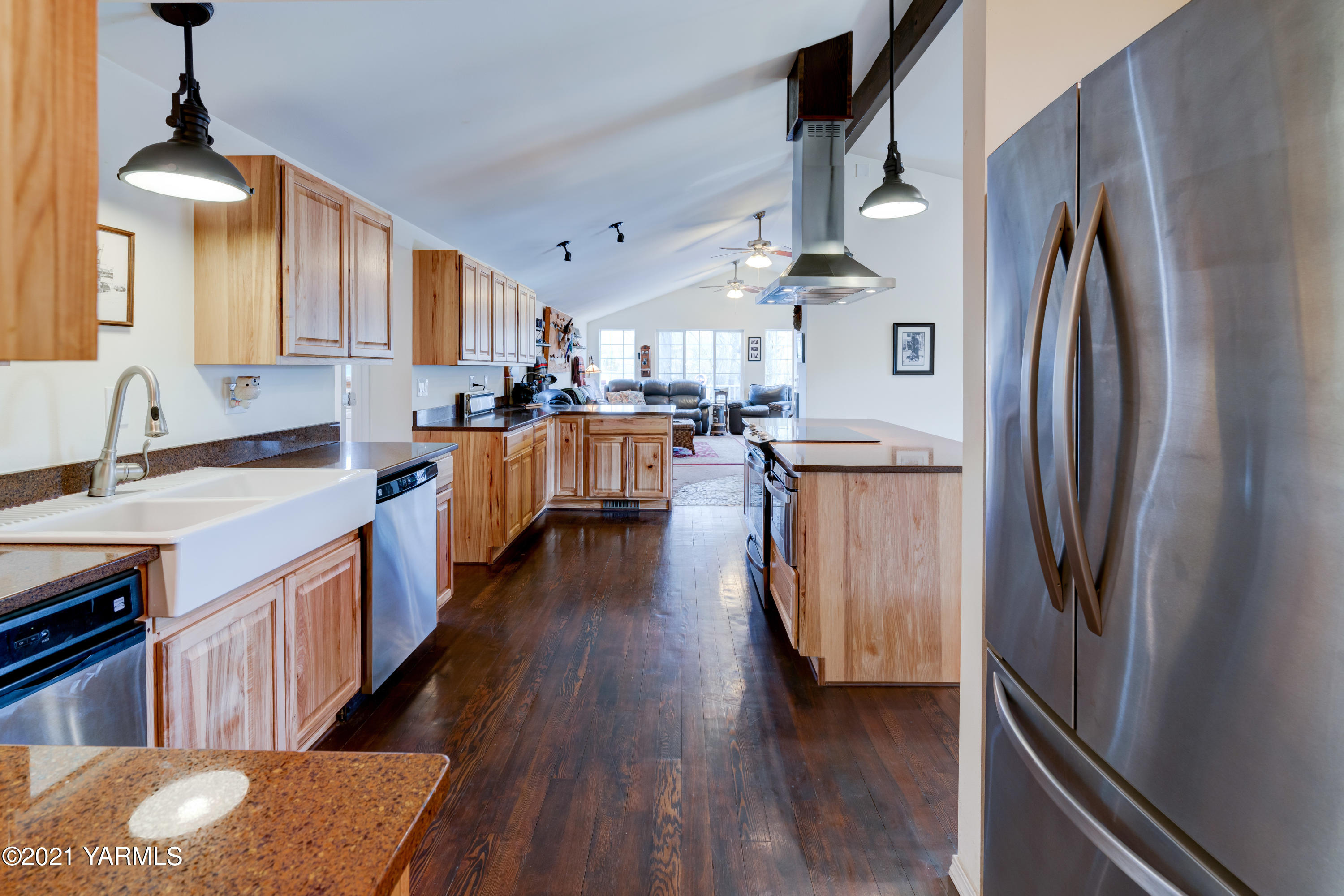 10805 Summitview Ext Road Yakima, WA 98908 - Photo 8 of 27 a kitchen with stainless steel appliances granite countertop a refrigerator a sink dishwasher a stove and a dining table with wooden floor
