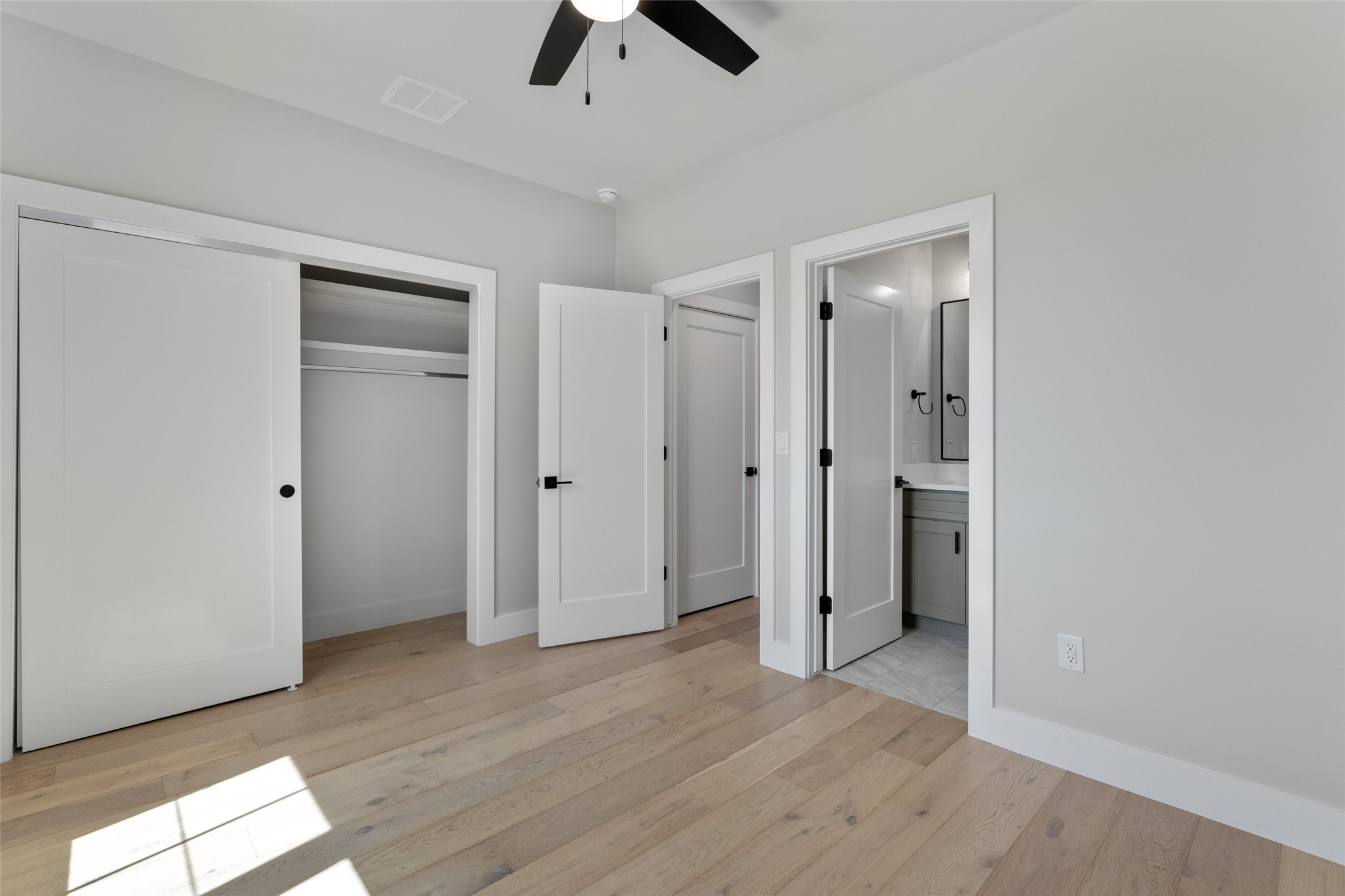5200 Grover Avenue Austin, TX 78756 - Photo 23 of 32 Secondary bedroom featuring hardwood flooring throughout, with a ceiling fan and recessed lighting.