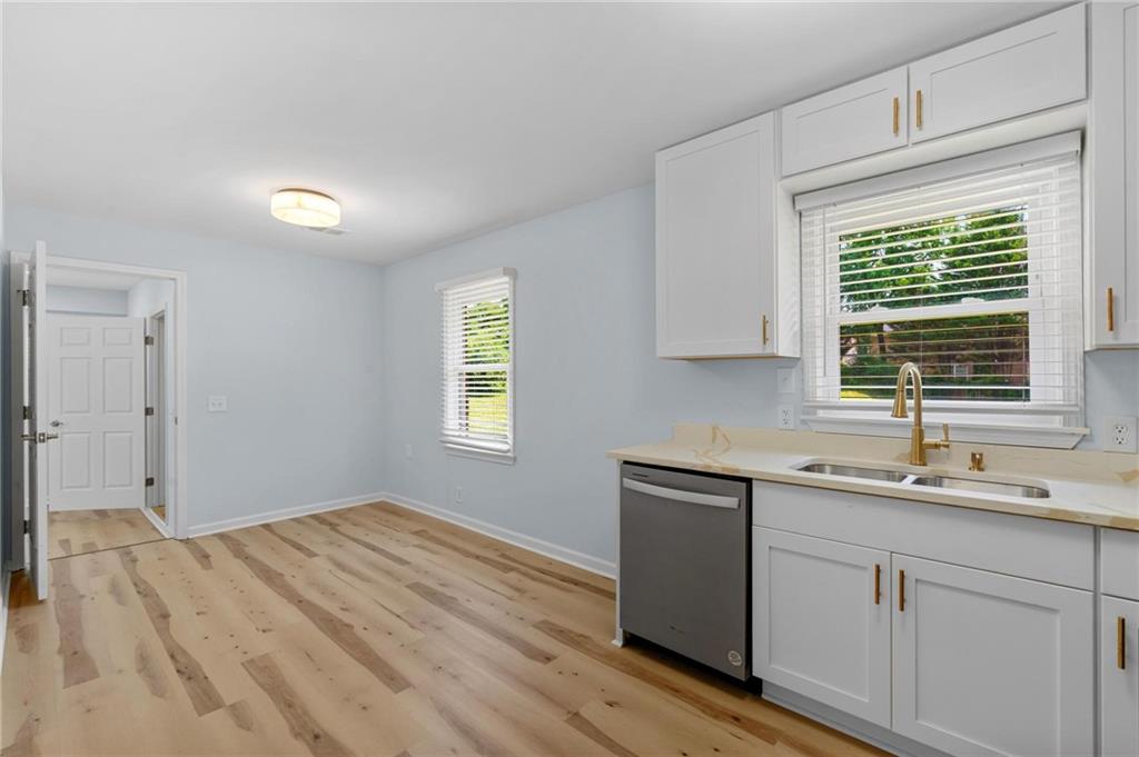 1745 Rockbridge Road Northwest Conyers, GA 30012 - Photo 11 of 32 a kitchen with a sink cabinets and window