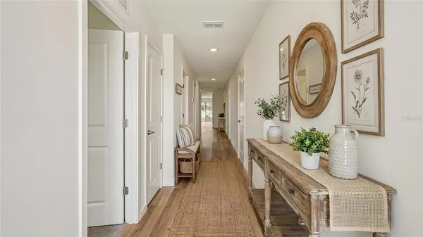a view of a hallway with entryway wooden floor and front door