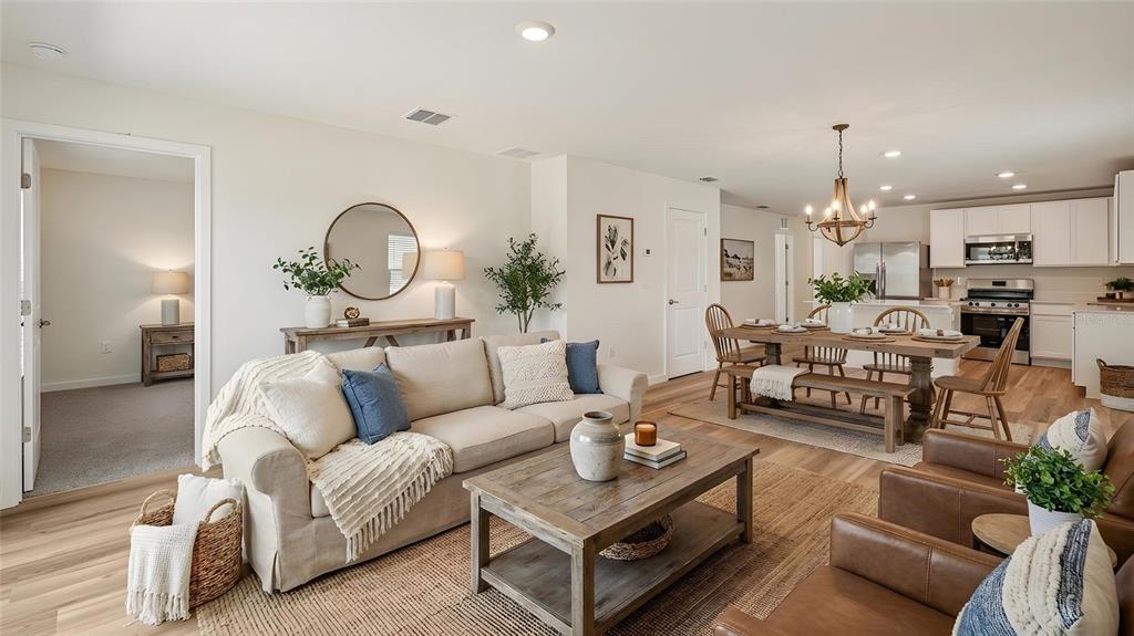 4035 Kona Circle Spring Hill, FL 34608 - Photo 3 of 19 a living room with furniture a chandelier and a fireplace