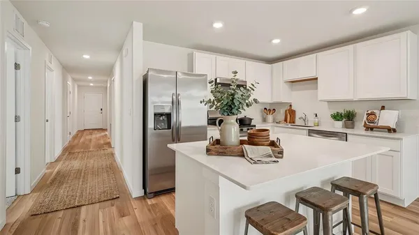 a kitchen with a table and chairs