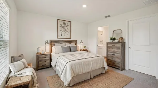 a bedroom with a bed and a dresser
