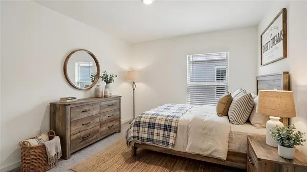a bedroom with a bed and a dresser