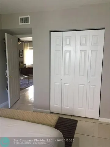 a view of a room with wooden floor and cabinet