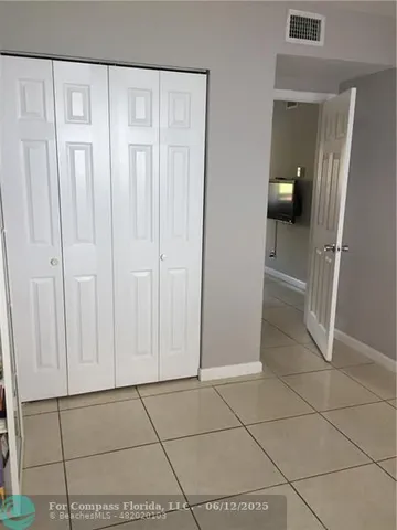 a view of a livingroom with an empty space and wooden floor