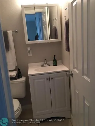 a bathroom with a toilet sink and vanity