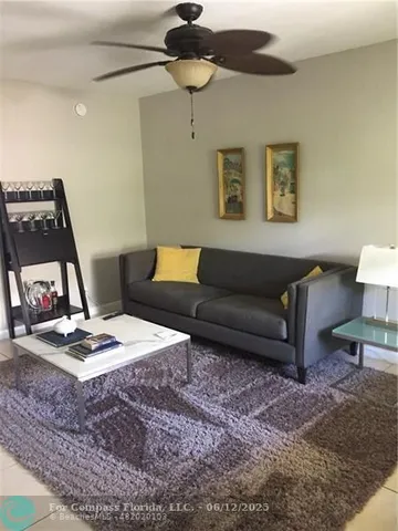 a living room with furniture and a rug