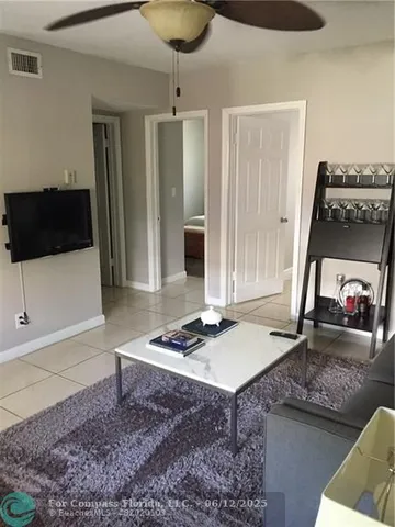 a living room with hard wood floor and a fireplace