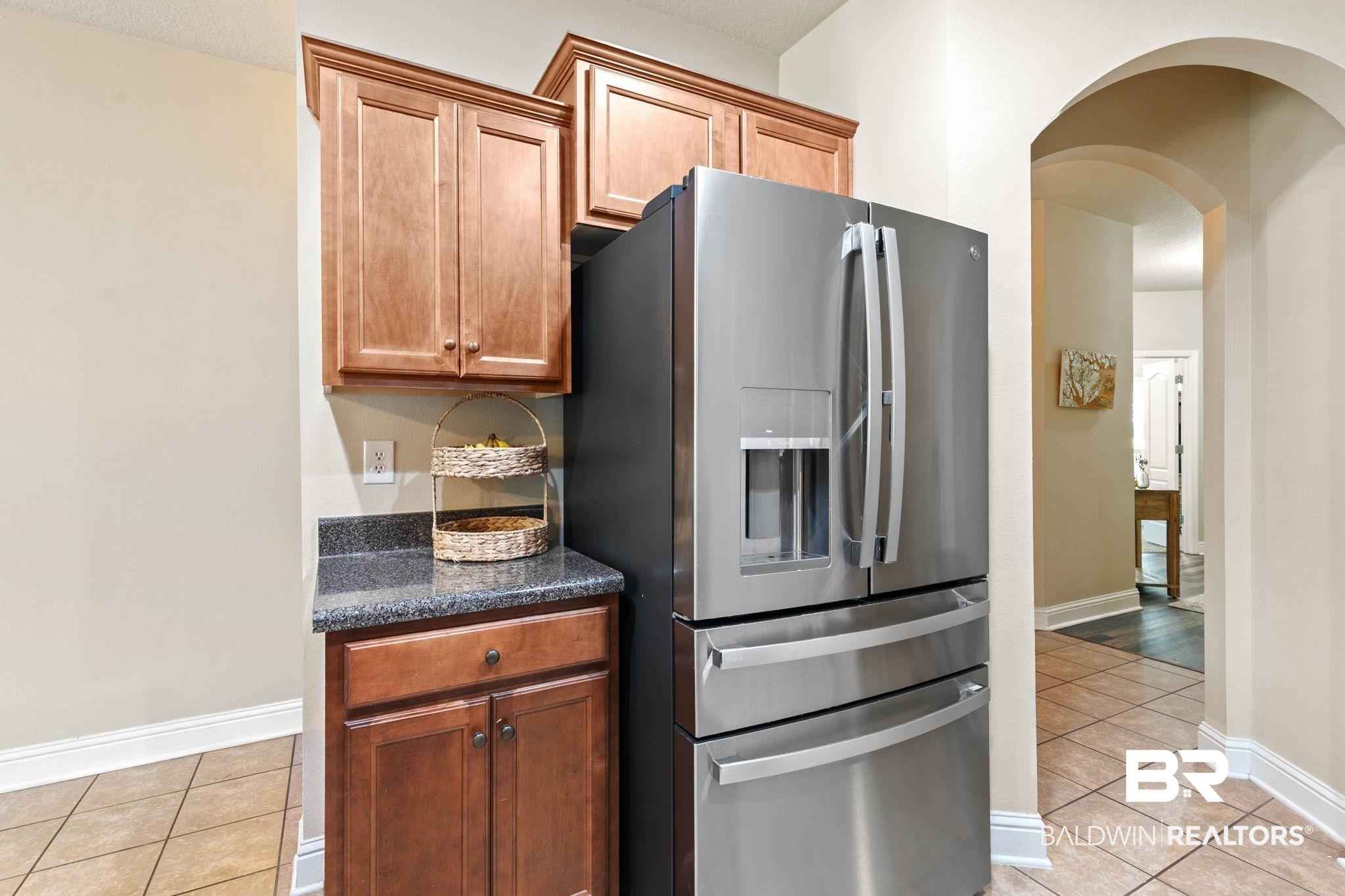 2216 Livingstone Court Mobile, AL 36695 - Photo 19 of 62 Stainless steel French door refrigerator set within warm wood-finish cabinetry