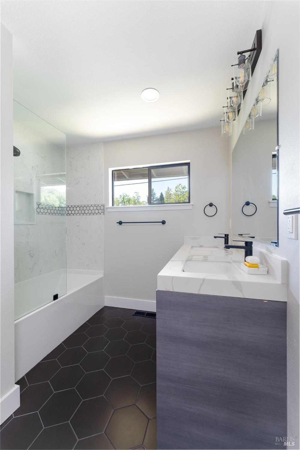 788 Walnut Avenue Ukiah, CA 95482 - Photo 22 of 36 a bathroom with a sink a large mirror and shower