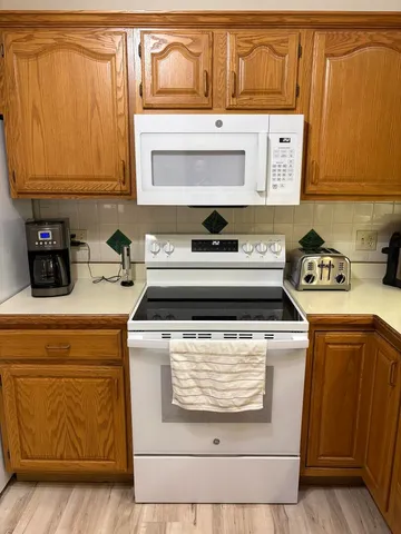 a stove top oven sitting inside of a kitchen