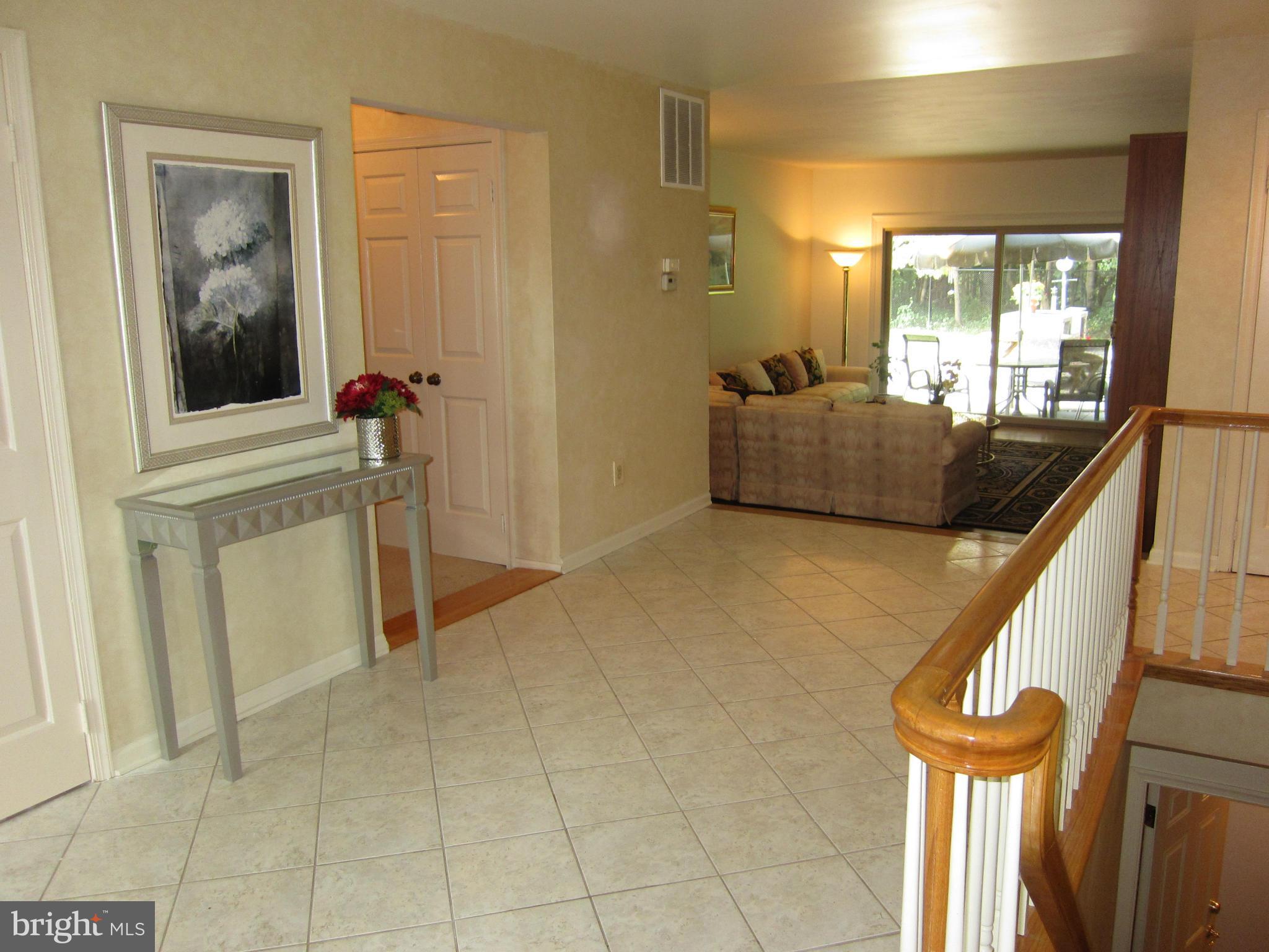 Open foyer with marble tile floor