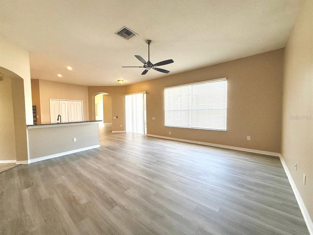 22320 Red Jacket Lane Land O' Lakes, FL 34639 - Photo 20 of 35 a view of an empty room with a window and wooden floor