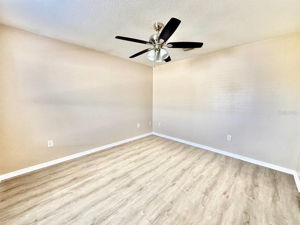 22320 Red Jacket Lane Land O' Lakes, FL 34639 - Photo 23 of 35 a view of a big room with wooden floor
