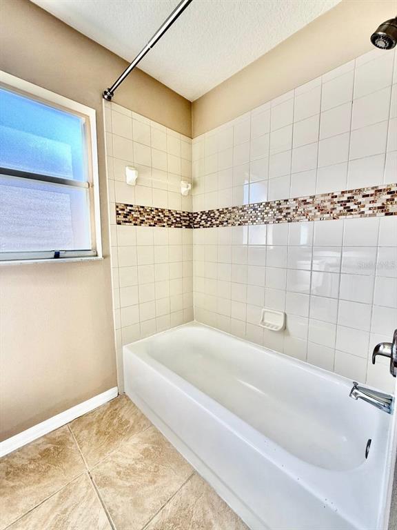 22320 Red Jacket Lane Land O' Lakes, FL 34639 - Photo 27 of 35 a bathroom with a bathtub and shower