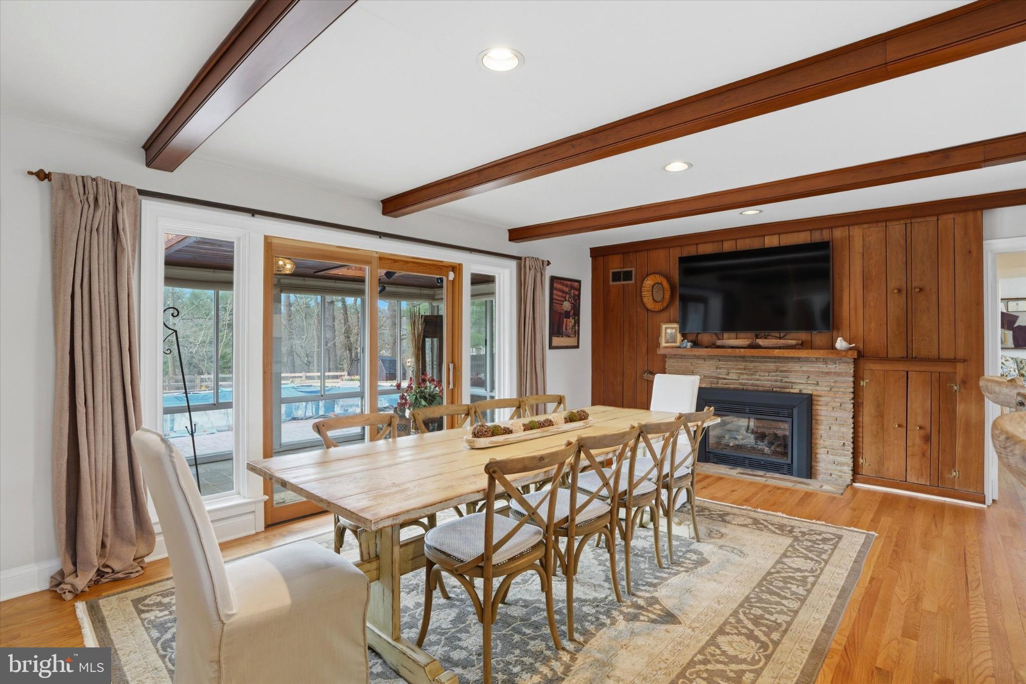 875 Locust Grove Road West Chester, PA 19382 - Photo 14 of 44 a dining room with furniture a fireplace and wooden floor