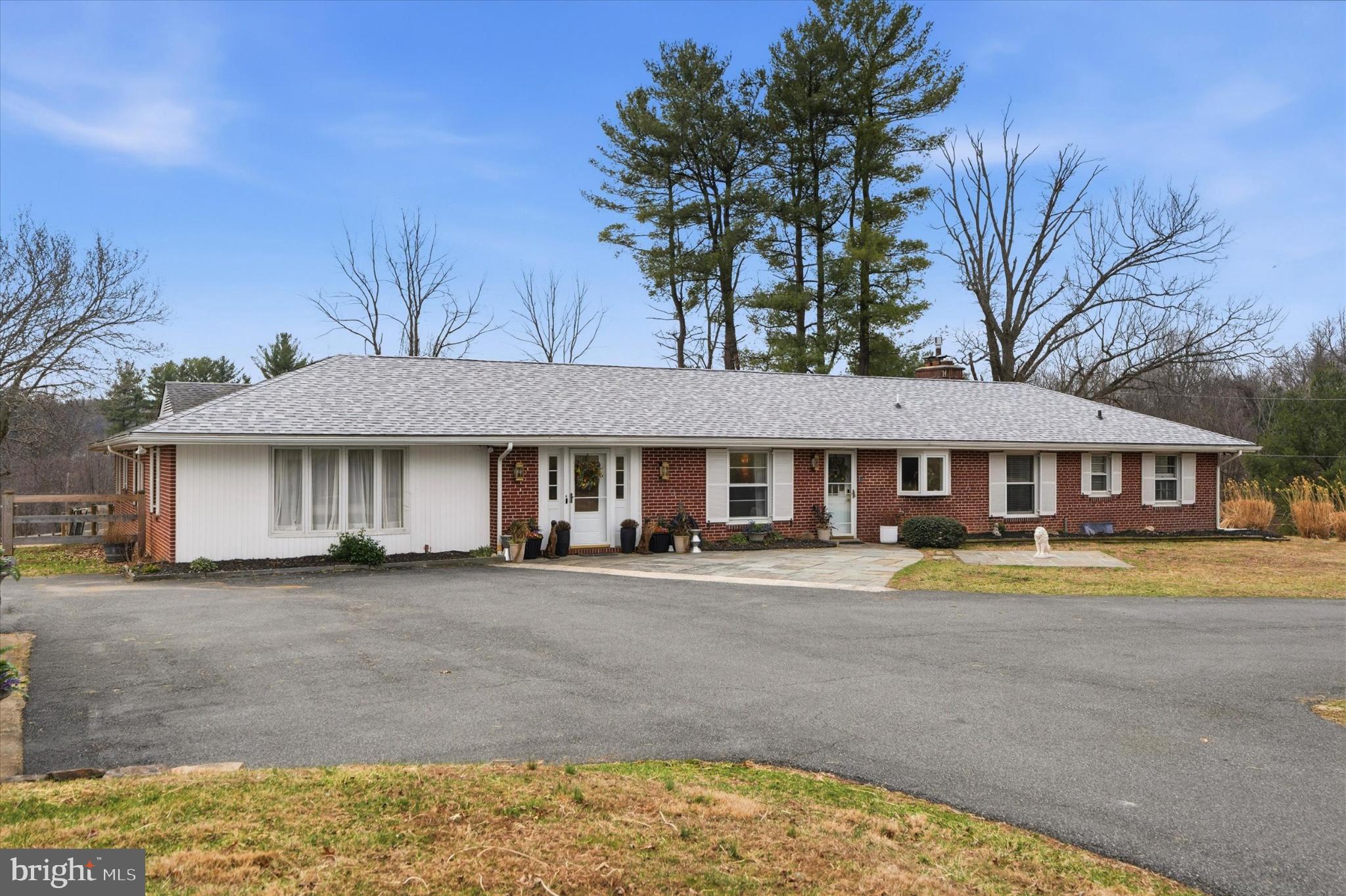 875 Locust Grove Road West Chester, PA 19382 - Photo 3 of 44 a front view of a house with a garden