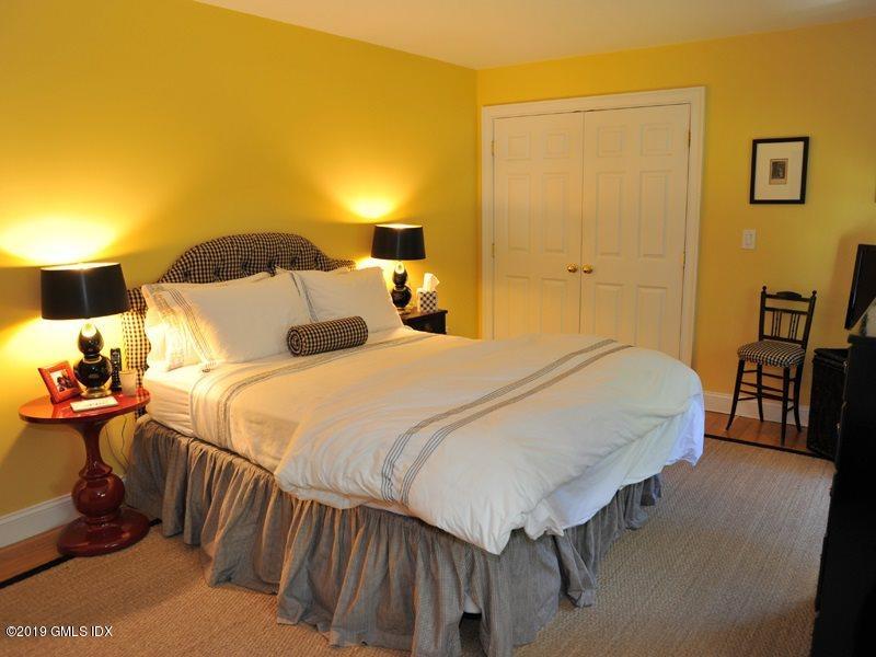 184 Cat Rock Road Cos Cob, CT 06807 - Photo 15 of 25 a bedroom with a bed and wooden floor