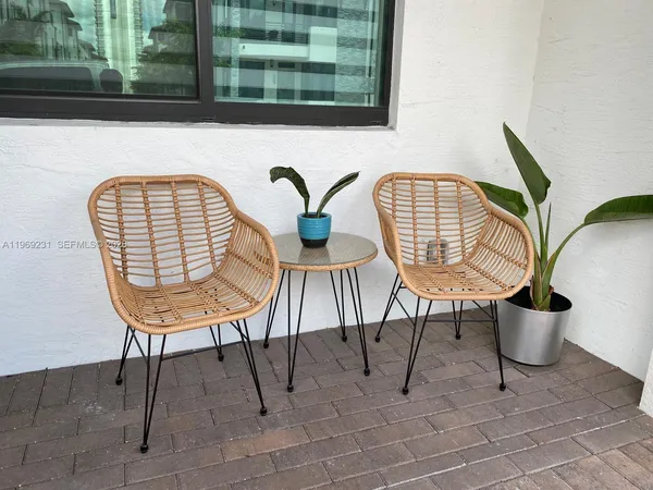 a view of a chair and table in the balcony