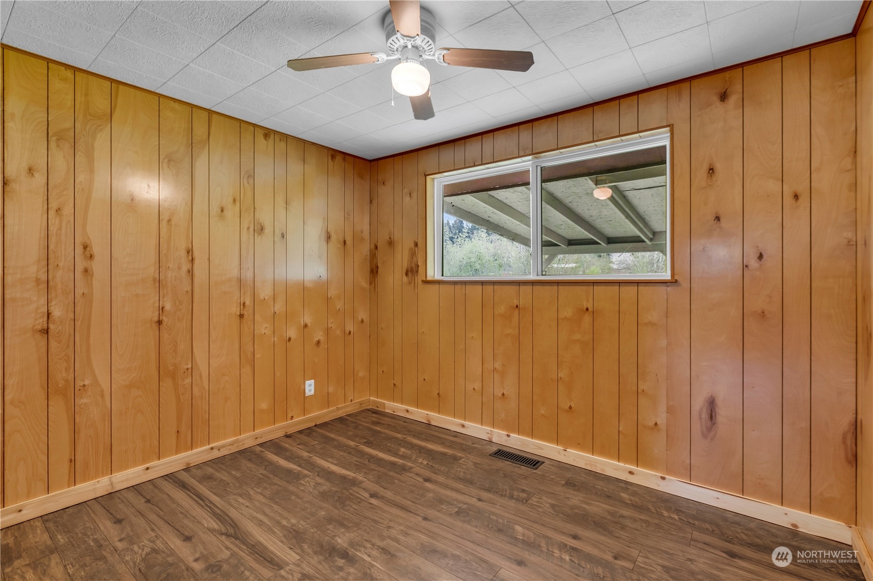 2093 Ryan Road Buckley, WA 98321 - Photo 14 of 25 an empty room with wooden floor chandelier fan and windows