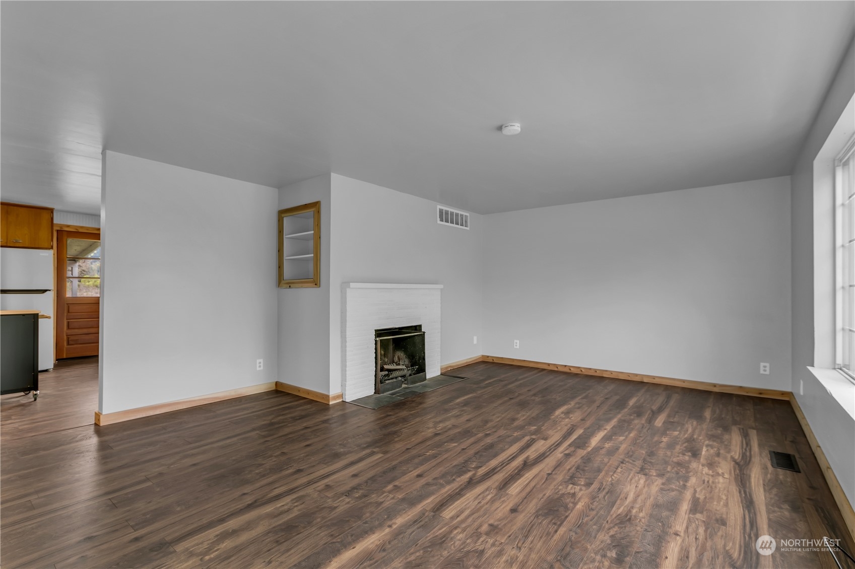 2093 Ryan Road Buckley, WA 98321 - Photo 4 of 25 a view of empty room with wooden floor and fireplace