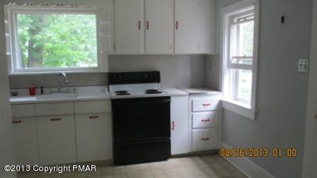 231 Tanite Road Stroudsburg, PA 18360 - Photo 6 of 14 a kitchen with a stove a sink and a window